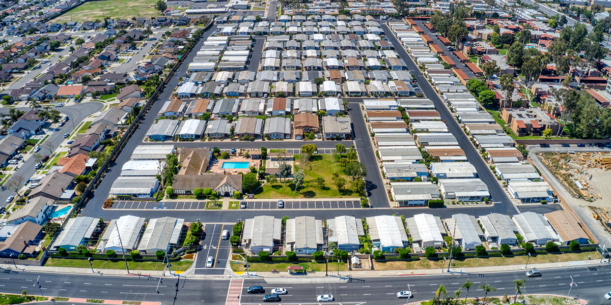 aerial photo of mobile homes with a park in the middle 